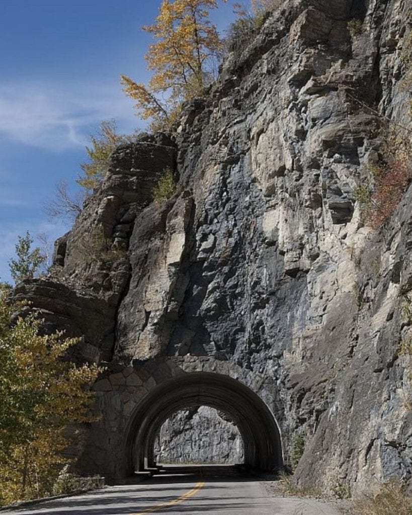 The western tunnel cuts through rocky mountainside on Going-to-the-Sun Road