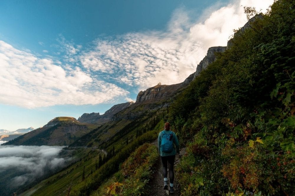 A hiker walks along the Highline Trail in Glacier National Park.