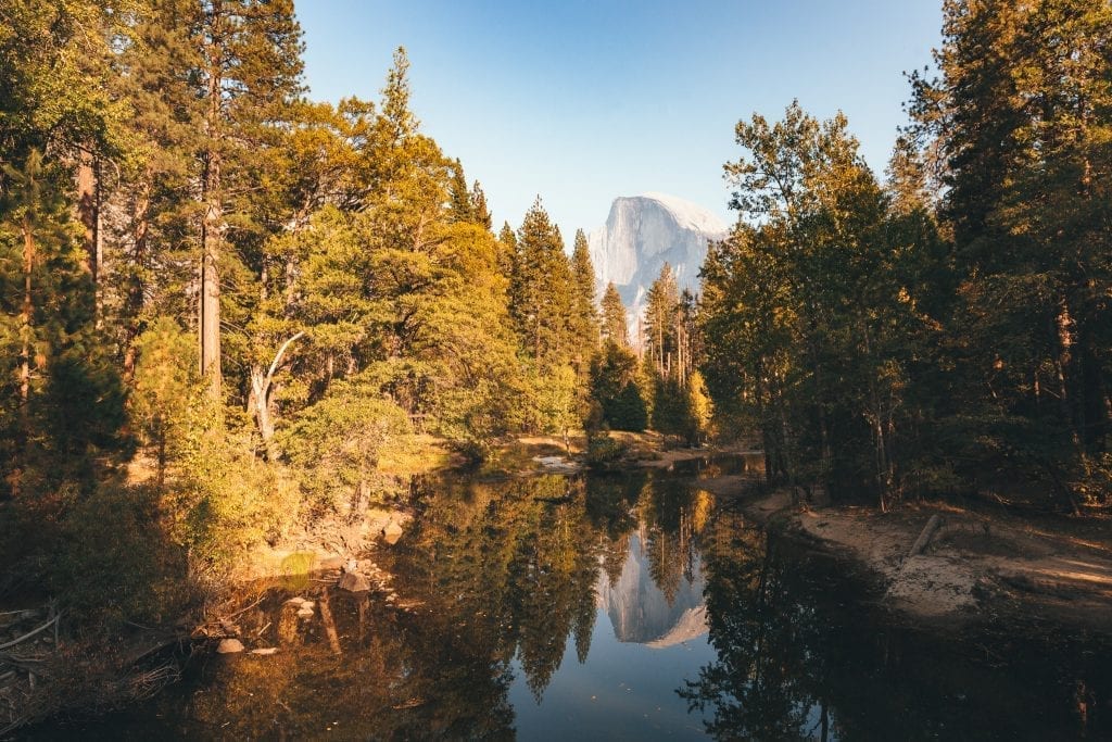 Half Dome is reflected in the Merced River as seen from Sentinel Bridge in Yosemite Valley