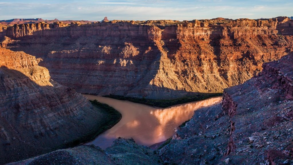 Two rivers merge at the bottom of a canyon at the Confluence Overlook in Canyonlands