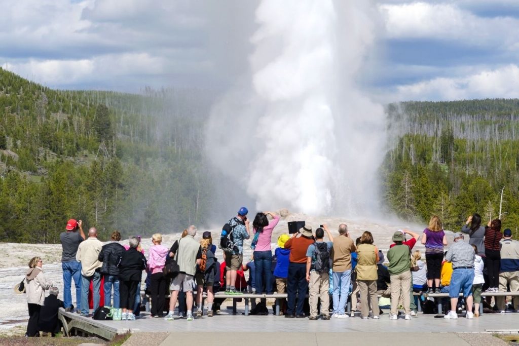 Crowds gather around Old Faithful Geyser eruption in Yellowstone