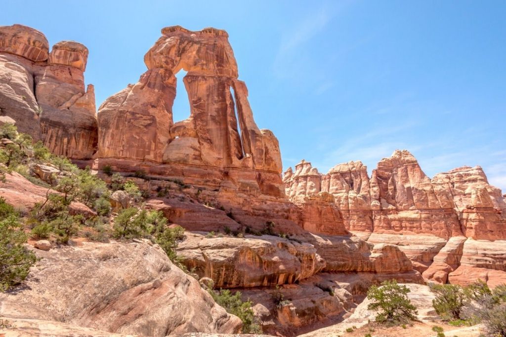 A tall archway of two rocky leaning against each other - Druid Arch in Canyonlands