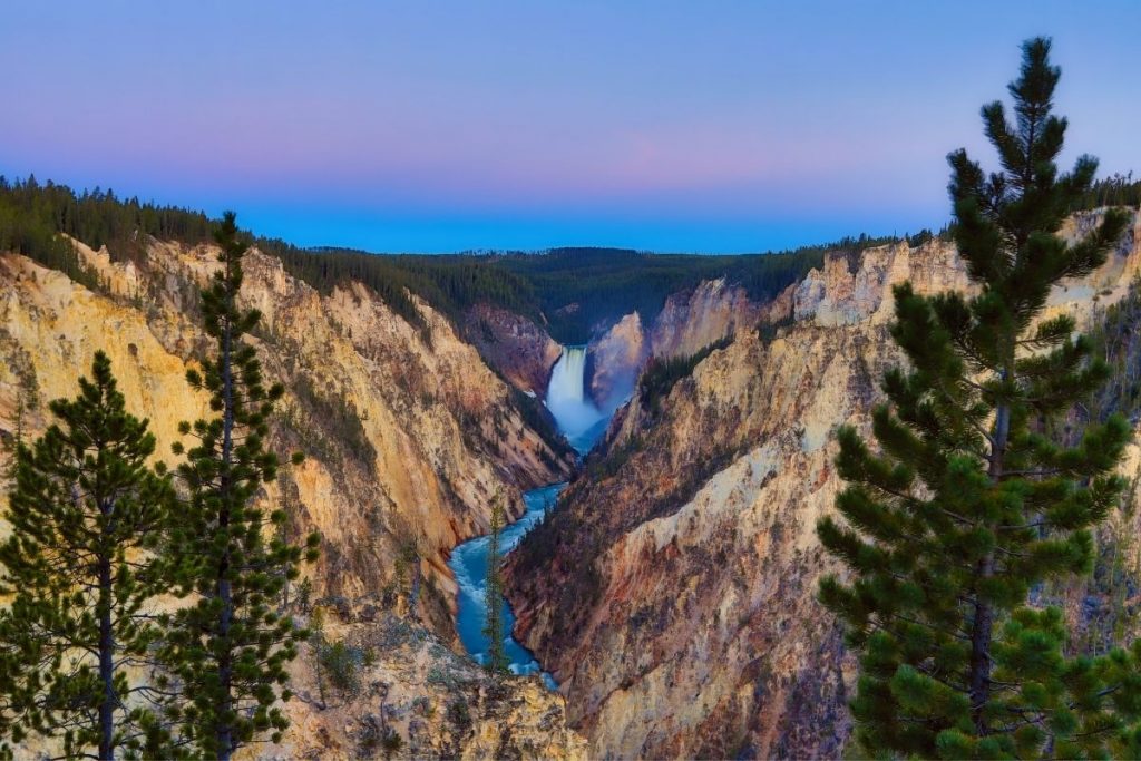 Sunset over a distant waterfall in Yellowstone