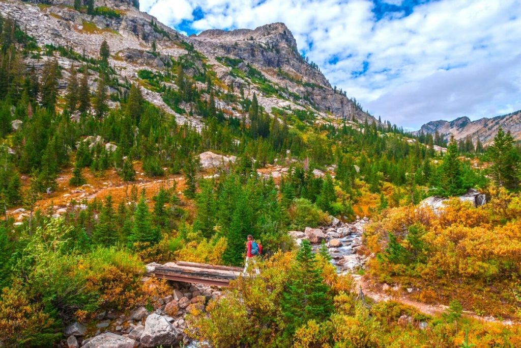 Hiker walks through Cascade Canyon in Grand Teton National Park