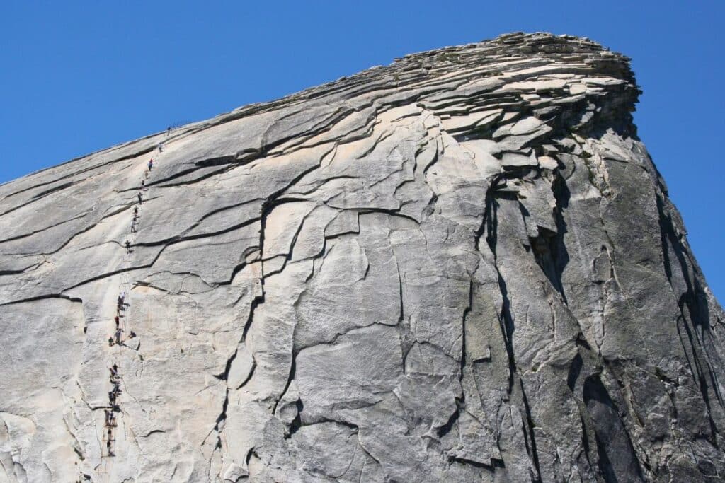 Hikers climbing the cables on Half Dome in Yosemite