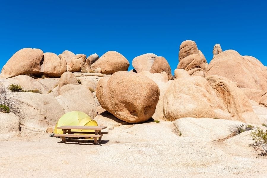 A yellow tent at a campsite in Jumbo Rocks Campground in Joshua Tree