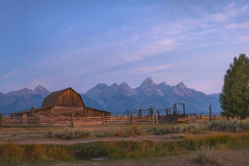 Old wooden barn at Mormon Row in front of the Teton Mountain Range