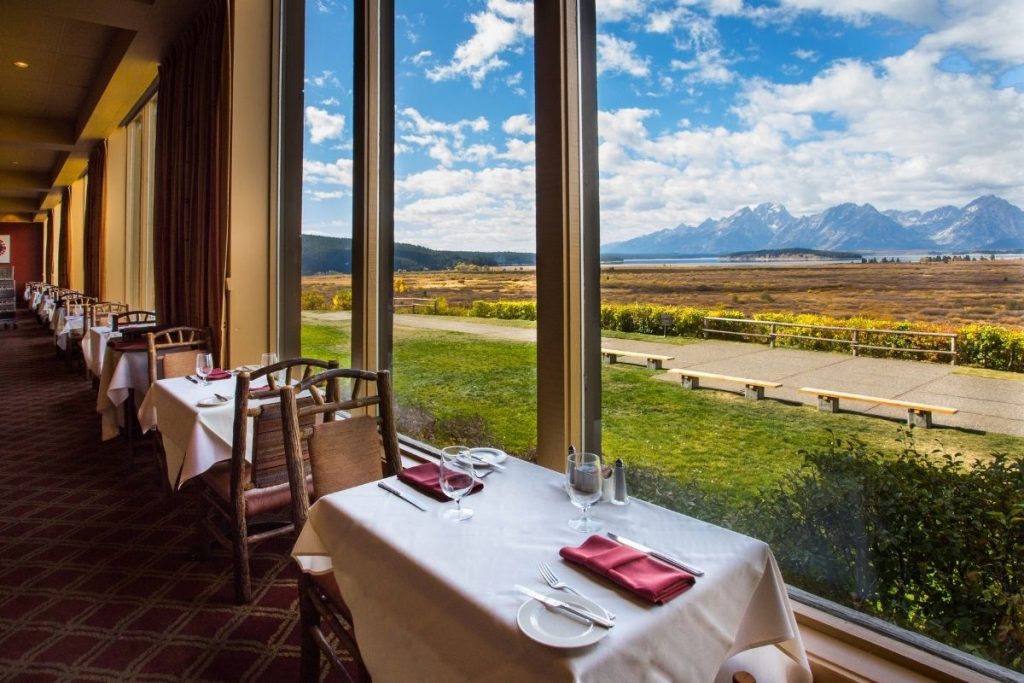 Dinner table with mountain views in the Mural Room at Jackson Lake Lodge in Grand Teton