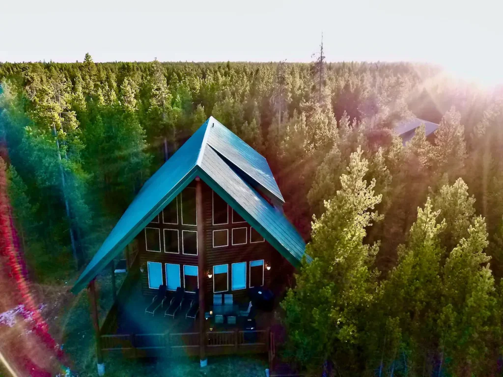 Cabin tucked in dense woods at sunset