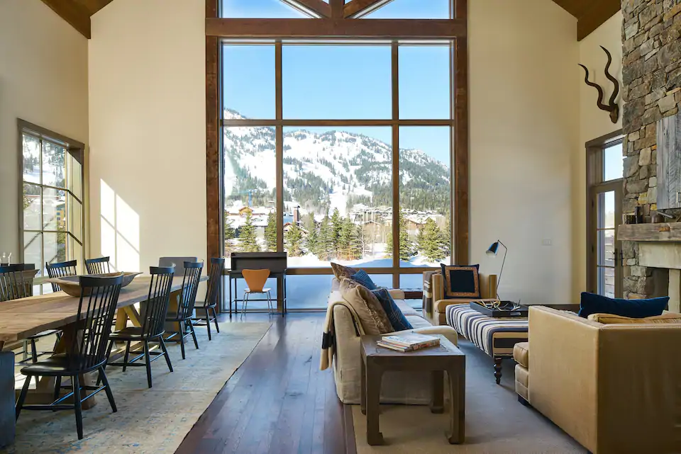 Large, luxury living room with floor-to-ceiling window with Teton views