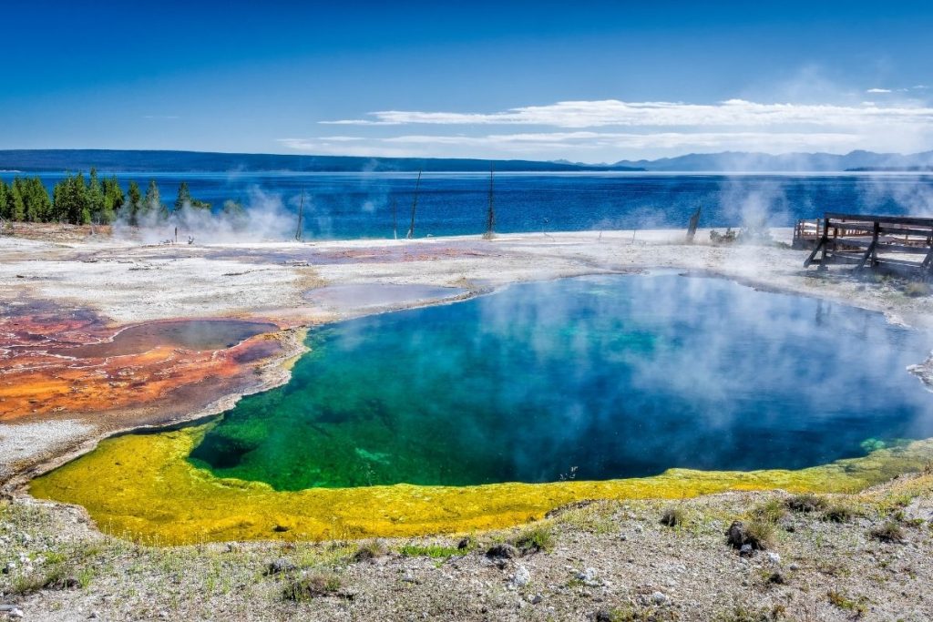 Yellow, green, and blue hot spring overlooking Yellowstone Lake