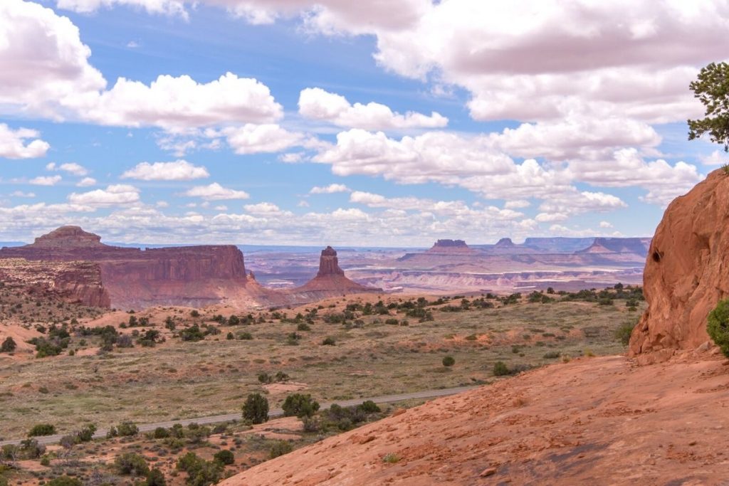 Distance rock formations and grassy field from Whale Rock in Canyonlands