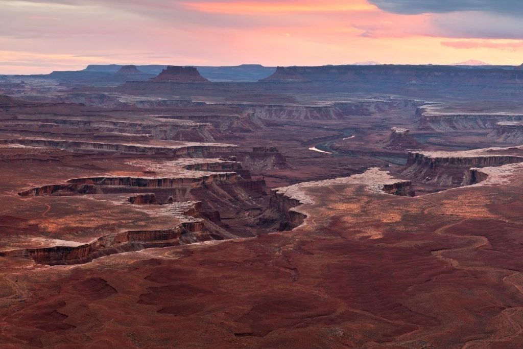 Sunset views over a wide canyon from White Rim Overlook in Canyonlands